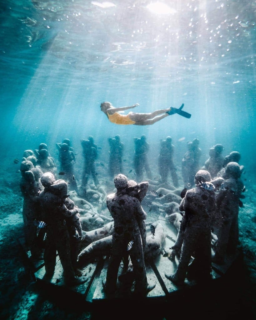 Snorkeler above the Bask Nest underwater sculpture circle at Gili Meno