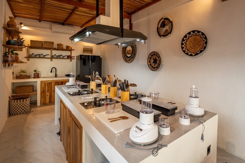 Individual cooking stations with gas hobs and prep space at the Cooking on Meno kitchen studio, Gili Meno